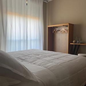 a bedroom with a large bed and a window at Civico 48 in Vizzola Ticino