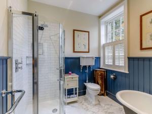 a bathroom with a shower and a toilet and a sink at 5 bed in Markington 83892 in Bishop Thornton +23 photos
