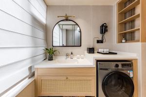 a bathroom with a sink and a washing machine at Tree House Dali 清朴小院 大理 in Dali Airport +75 photos