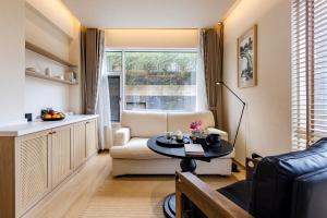 a living room with a couch and a table at Tree House Dali 清朴小院 大理 in Dali Airport