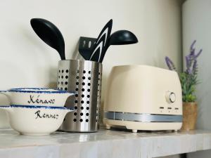 a counter with a toaster and bowls on it at Auréa - Elégant Duplex Rennes in Rennes