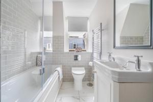 un bagno bianco con lavandino e WC di Boutique Bath Apartment, Minutes from Shops & Spas a Bath