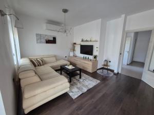 a living room with a couch and a tv at Apartmani Nika in Rijeka