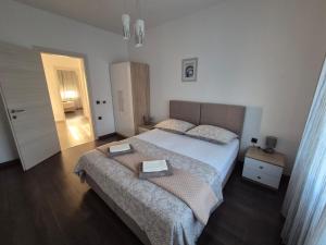 a bedroom with a bed with two boxes on it at Apartmani Nika in Rijeka
