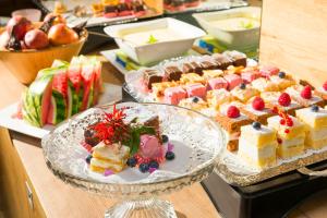 a buffet filled with different types of cakes and fruit at Hotel Muhr in Pöllauberg