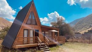 a small cabin with a gambrel roof at Cottage View in Kazbegi +4 photos