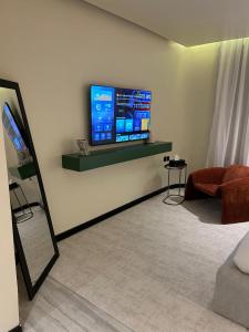 a living room with a flat screen tv on a wall at ovation Studio in Riyadh