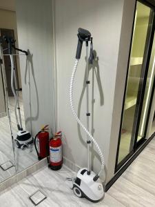 a hair dryer on the corner of a room at ovation Studio in Riyadh +4 photos