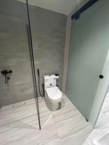 a bathroom with a white toilet in a stall at ovation Studio in Riyadh
