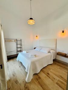 a white bedroom with a bed in a room at Complejo turístico en Trebujena by Villamya in Trebujena +44 photos
