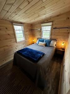 a bedroom in a wooden cabin with a large bed at Bear Lake Retreat in Lake
