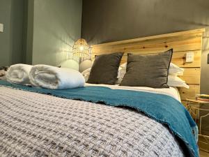 a large bed with a white dog laying on it at CityScape Nest Suite Unit 2 in Mossel Bay