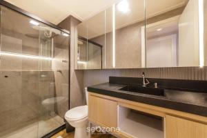 a bathroom with a sink and a toilet and a shower at House with Jacuzzi, just 10min from the sea OSH in Florianópolis +5 photos