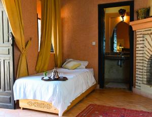 a bedroom with a bed with a table on it at Riad Sidi Hicham in Marrakech +62 photos