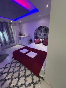 a bedroom with a large bed with two towels on it at Luna Room in Baia Mare