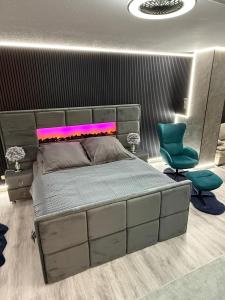 a bedroom with a bed and a blue chair at Modern luxury apartment in Koblenz in Koblenz