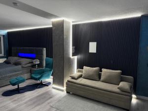 a bedroom with a bed and a couch and a chair at Modern luxury apartment in Koblenz in Koblenz +13 photos