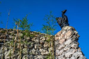 a statue of a bird sitting on top of a rock wall at Jiya Villa Uluwatu - Panoramic Terraces with Stunning Views, Luxury Service and Entertainment in Uluwatu