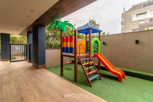 a playground with a slide and a ladder at Ap c/ churrasq e piscina 350m praia Jurerê JPR201 in Florianópolis