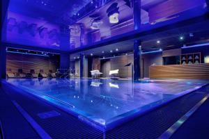 a dance floor with a pool in a room at Bristol Art & Medical SPA in Busko-Zdrój