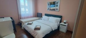 a small bedroom with a bed and a window at Arty's Apartment in Trieste