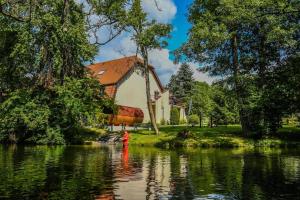 a house with a fire hydrant in the middle of a river at Kompleks Wypoczynkowo-Konferencyjny Mazur-Syrenka in Krutyń +26 photos
