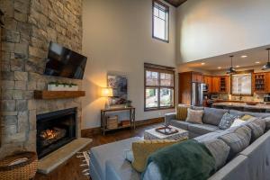 a living room with a couch and a fireplace at Overlook Nook at Eagles Nest in Elk Park