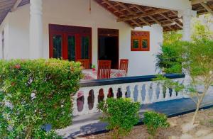 a porch of a house with a table and chairs at Dream Image in Midigama East