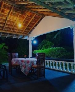 a table and chairs on a patio at night at Dream Image in Nikawatawana +7 photos