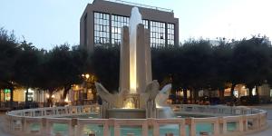 a large white monument in front of a building at Cairoli's View in Brindisi