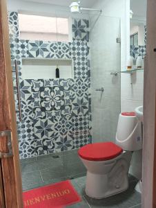 a bathroom with a toilet with a red seat at Apartamento en jardin in Jardin +6 photos