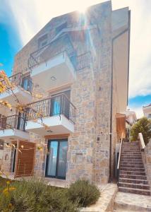 a brick building with stairs and a balcony at olives tree in Datca +27 photos