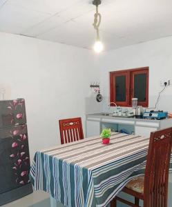a kitchen with a table with a plant on it at Dream Image in Nikawatawana