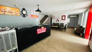 a living room with a bar and a living room with a waiting area at Collection O South City 1 Arcadia in Gurgaon