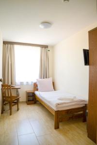 Posteľ alebo postele v izbe v ubytovaní ZGODA Kompleks Hotelarski