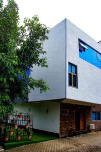 a building with a tree in front of it at The Glass Residence Jabi in Abuja
