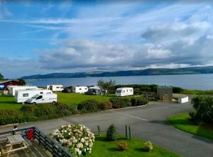 a view of a campsite with a view of the water at Loch View 30 in Stranraer