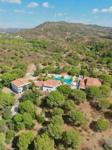 an aerial view of a house with two windmills at Quinta do Vale Entire Property in São Bartolomeu de Messines