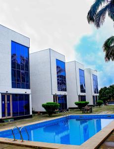 a building with a swimming pool in front of it at The Glass Residence Jabi in Abuja