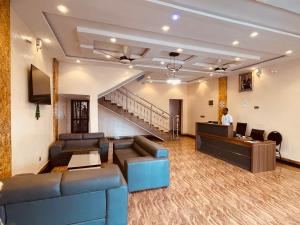a lobby with couches and a desk in a building at Reine Hôtel in Bohicon