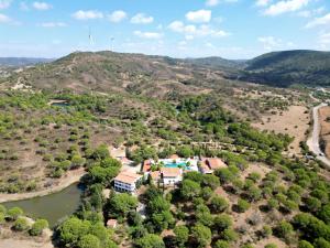 an aerial view of a house on a hill next to a river at Quinta do Vale Entire Property in São Bartolomeu de Messines