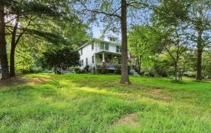 a white house with trees in the yard at Badby Wood Farmhouse 3BR 3BA Fauquier County in Marshall