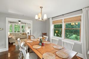 a dining room with a wooden table and chairs at Badby Wood Farmhouse 3BR 3BA Fauquier County in Marshall
