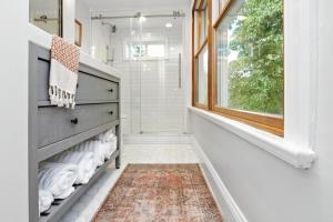 a bathroom with a large window and a shelf with towels at Badby Wood Farmhouse 3BR 3BA Fauquier County in Marshall +38 photos