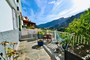a balcony of a house with a view of the mountains at Lovely Apartment For Rent In Beautiful Mogan - Gran Canaria in Mogán