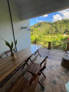a wooden table and two chairs on a deck at Pousada Rural João De Barro in Capela Ivapurunduva +16 photos