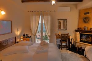 a bedroom with a large bed and a fireplace at Semeli Guesthouse in Karpenisi