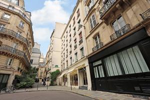 an empty street in a city with tall buildings at MODERN AND COSY FLAT- AC- 2Br-6P- NOTRE DAME in Paris
