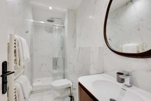 a white bathroom with a shower and a sink at MODERN AND COSY FLAT- AC- 2Br-6P- NOTRE DAME in Paris