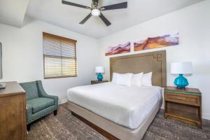 a bedroom with a bed and a chair at WorldMark Scottsdale in Scottsdale +51 photos